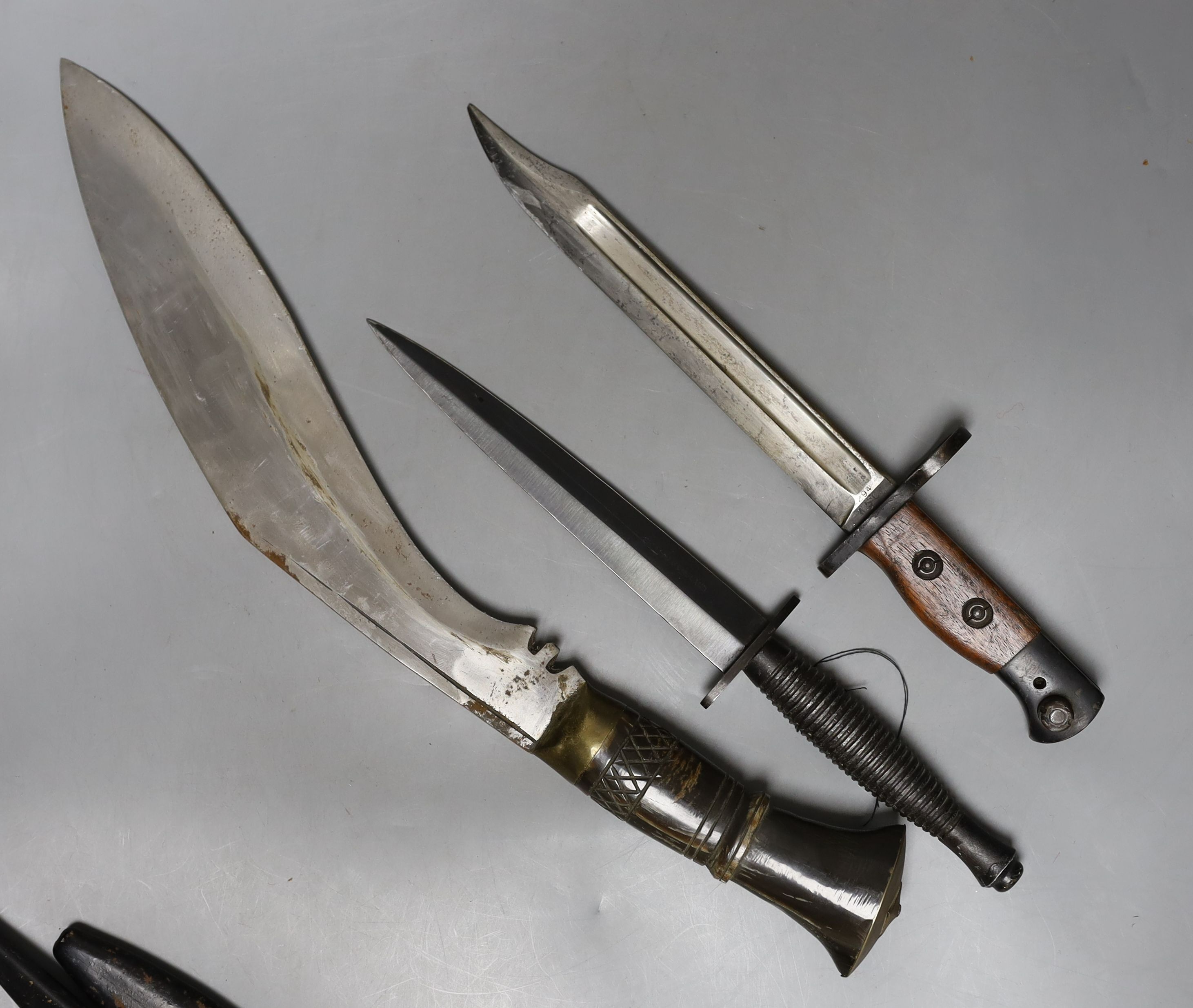 A kukri, small bayonet and a dagger, all with scabbards